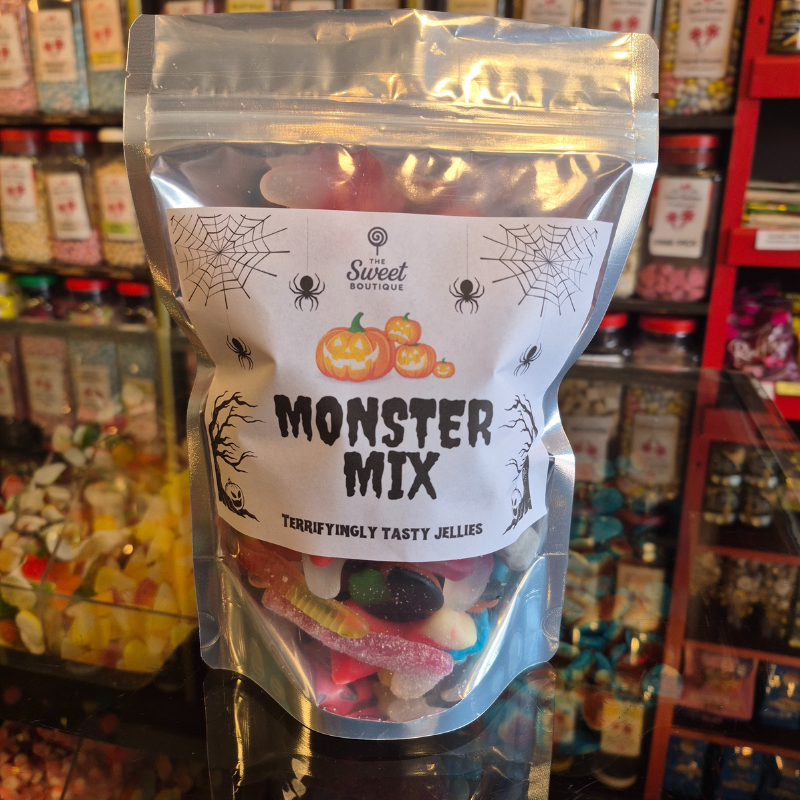 Packaged 'Monster Mix' jelly candies with a Halloween theme label, set against a store shelf background.