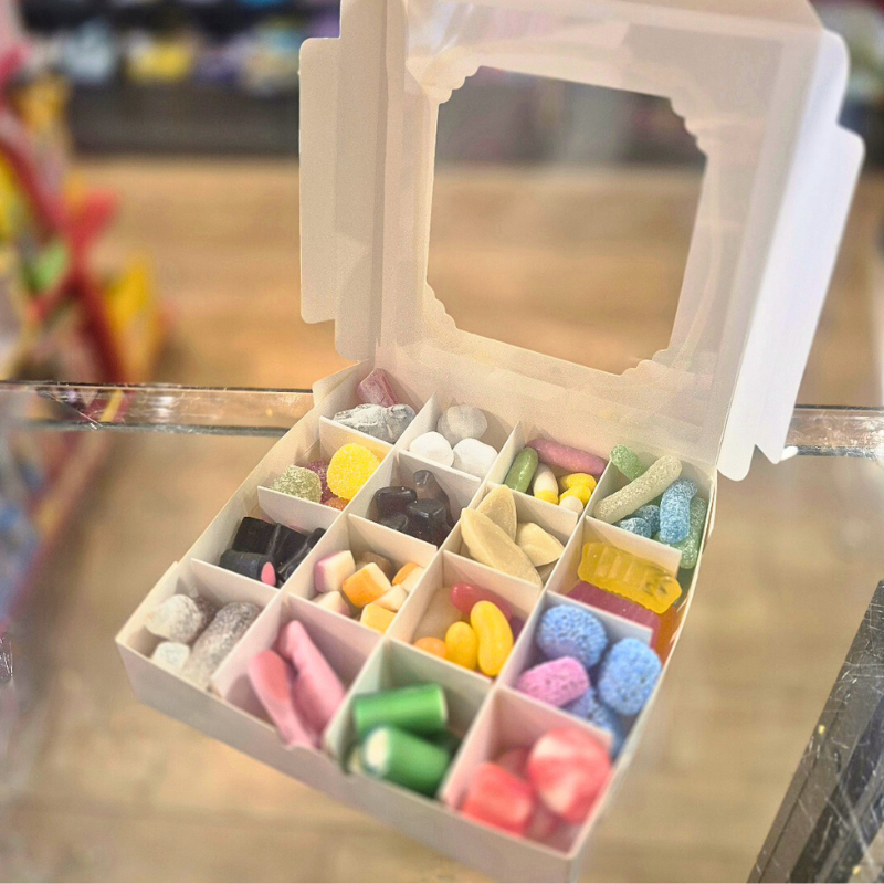 Colorful candy assortment in a small open box on a blurred background