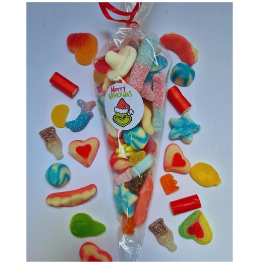 Colorful candy assortment in a clear bag with a 'Merry Grinchmas' label on a white background.