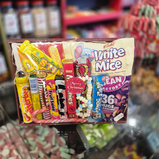 Assorted candy box with various brands on a store shelf.