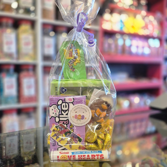 Packaged candy with a toy inside, set against a blurred store shelf background.